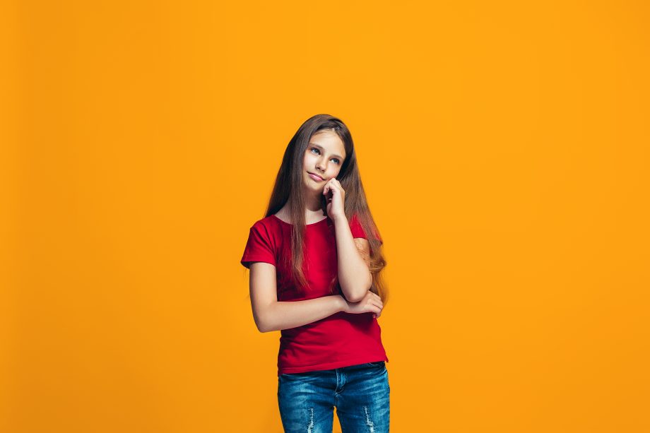 Young serious thoughtful teen girl. Doubt concept.